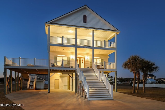 view of front of home with a balcony, covered porch, and a carport