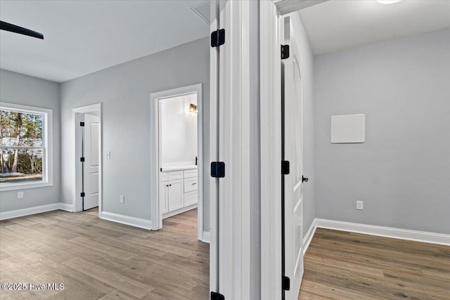 hallway with light wood-type flooring