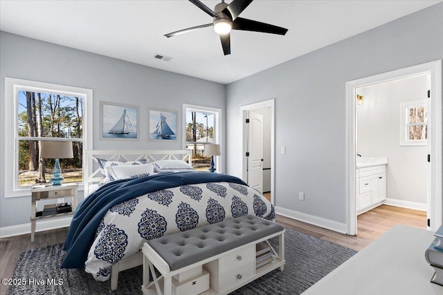 bedroom featuring hardwood / wood-style flooring, ceiling fan, and ensuite bathroom