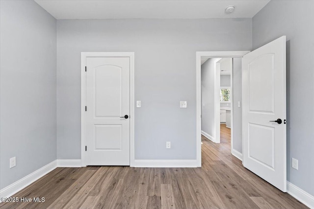 unfurnished bedroom featuring light wood-type flooring