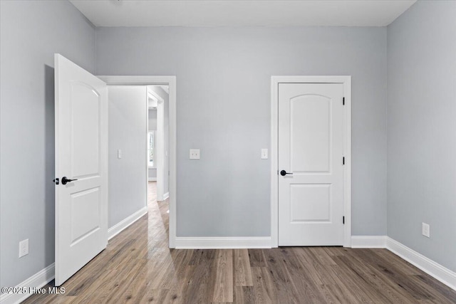 unfurnished bedroom featuring hardwood / wood-style flooring