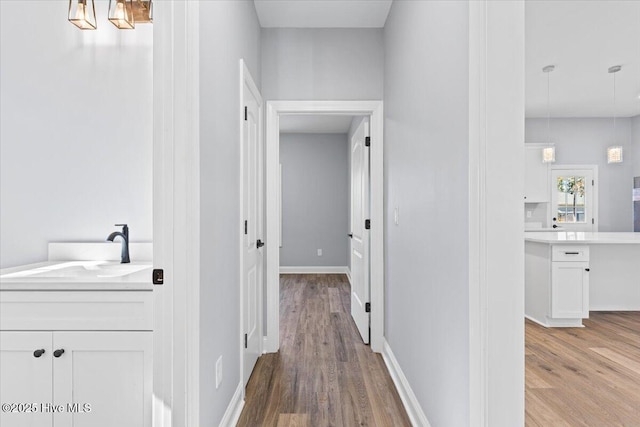 hall featuring sink and light hardwood / wood-style floors