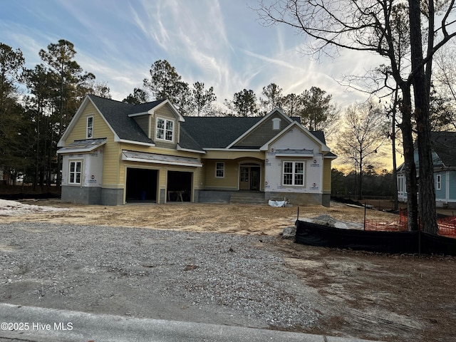 unfinished property featuring driveway and a garage