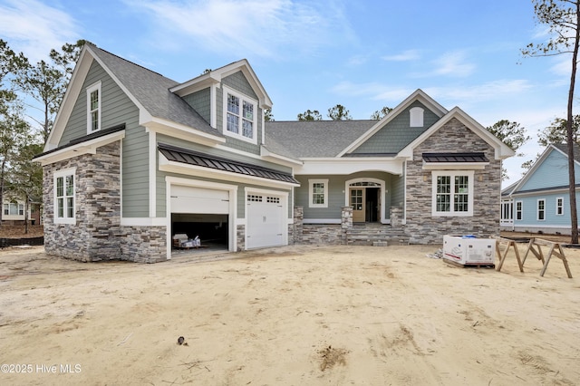 craftsman house with stone siding, driveway, roof with shingles, and an attached garage