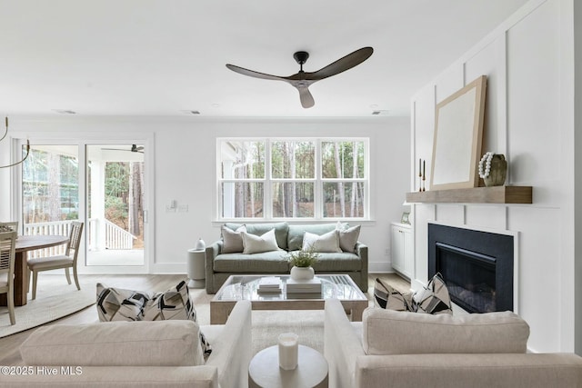 living room featuring ceiling fan and light hardwood / wood-style flooring