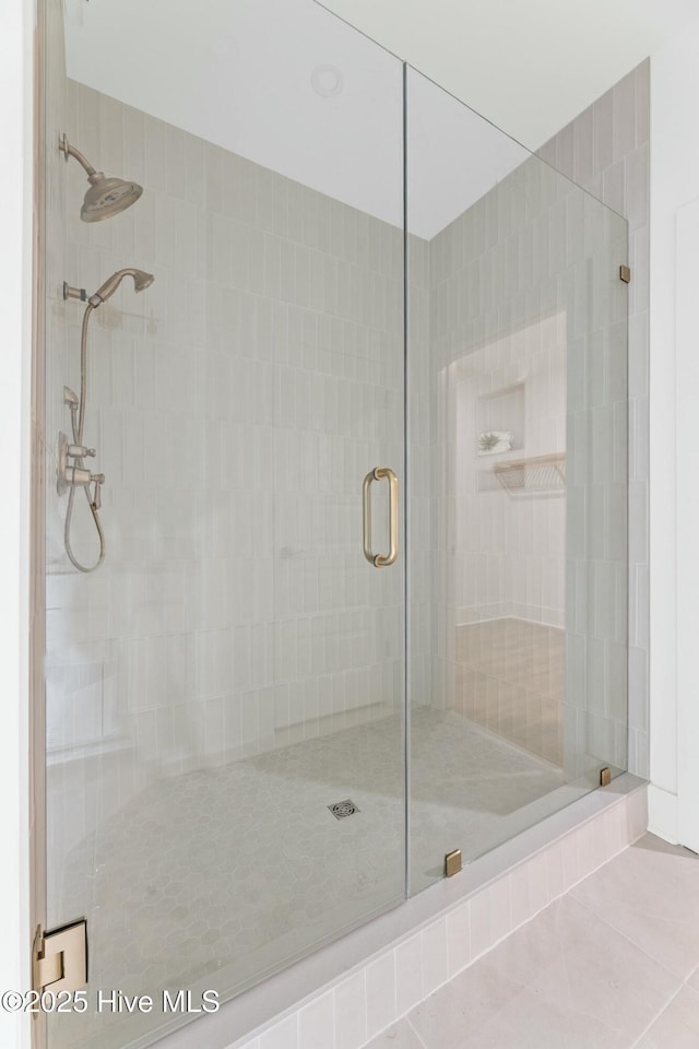 bathroom with walk in shower and tile patterned floors