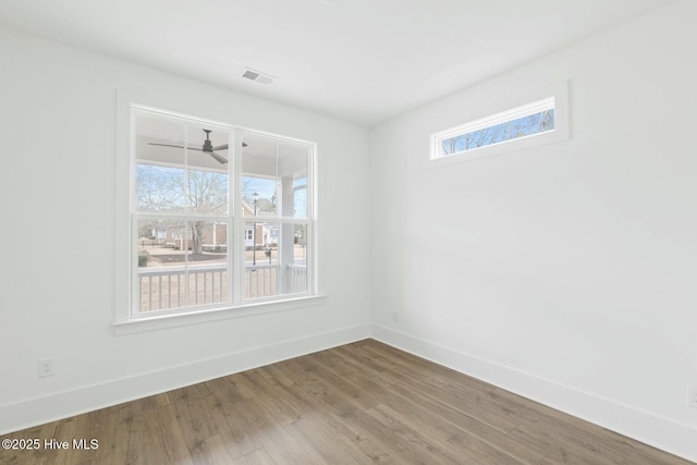 empty room with ceiling fan and hardwood / wood-style floors