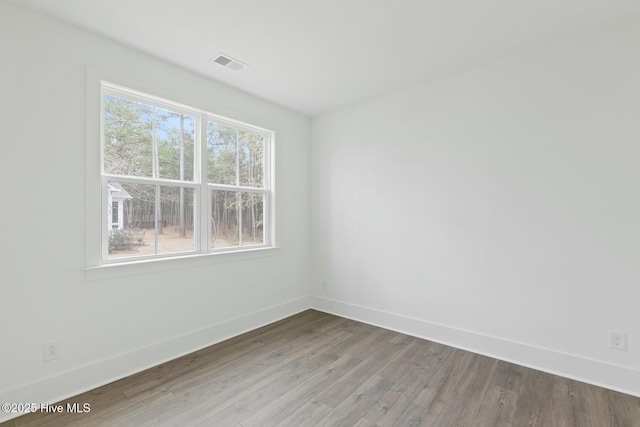 empty room with hardwood / wood-style flooring