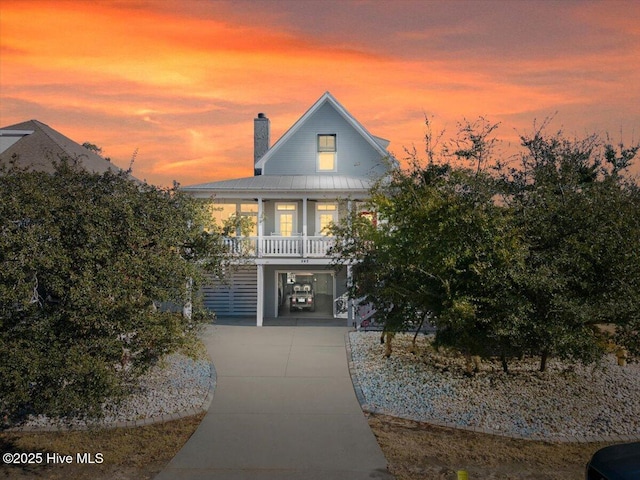 view of front of house with a porch and a carport