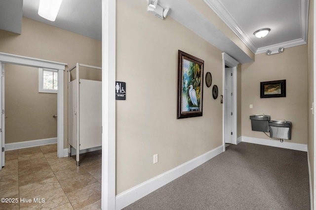 corridor with baseboards and ornamental molding