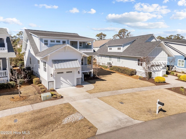 traditional-style home with driveway, a standing seam roof, a balcony, and board and batten siding