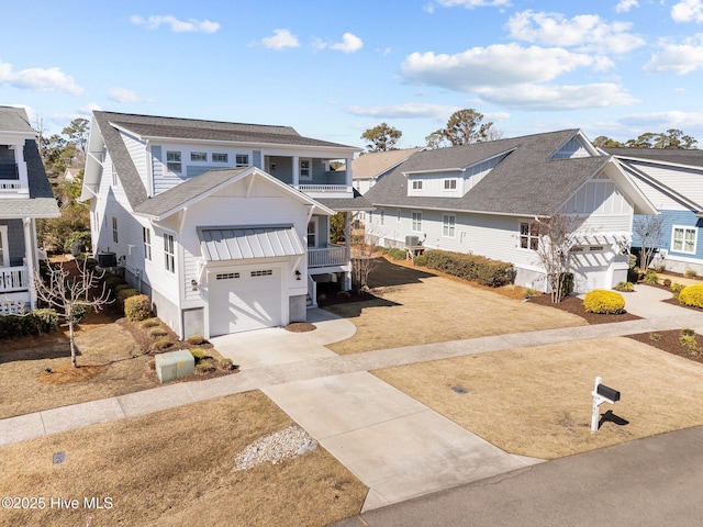 view of front of property with a balcony, a garage, concrete driveway, roof with shingles, and a residential view