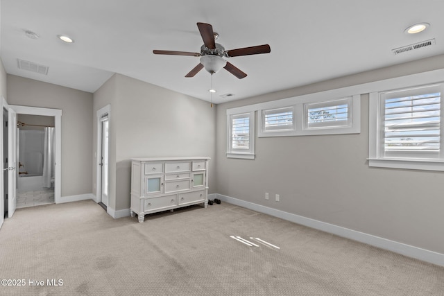 unfurnished bedroom with carpet, visible vents, and baseboards