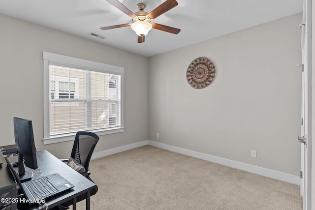 carpeted home office with baseboards, visible vents, and ceiling fan