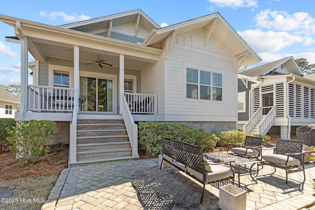 rear view of property featuring covered porch, a patio area, ceiling fan, and stairway