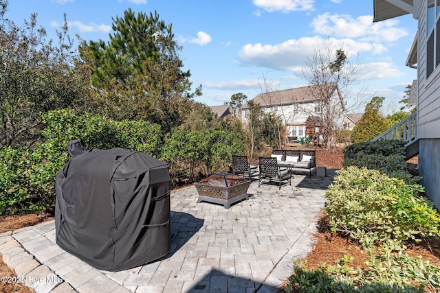 view of patio / terrace with an outdoor fire pit and grilling area