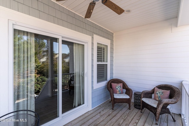 wooden terrace featuring a ceiling fan