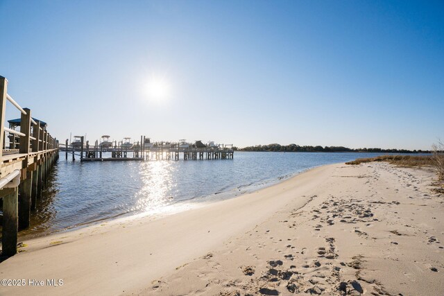 view of water feature with a dock and a view of the beach