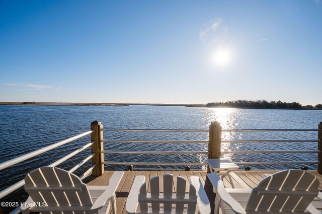 view of dock featuring a water view and a balcony