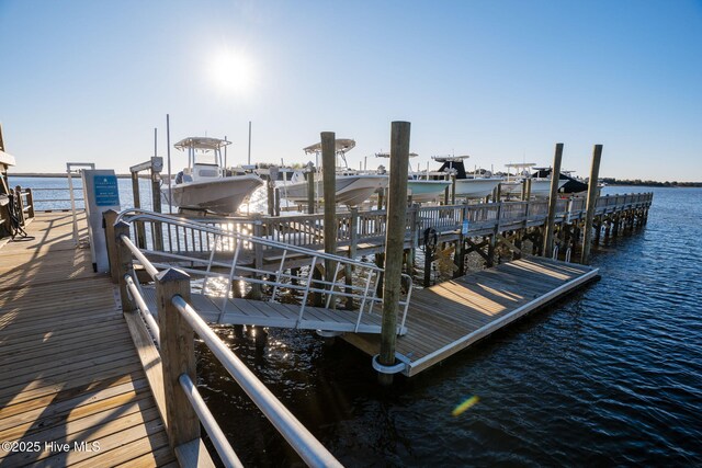 dock area with a water view and boat lift