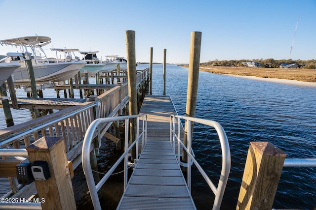 view of dock featuring boat lift and a water view