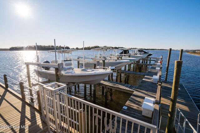 dock area with a water view and boat lift