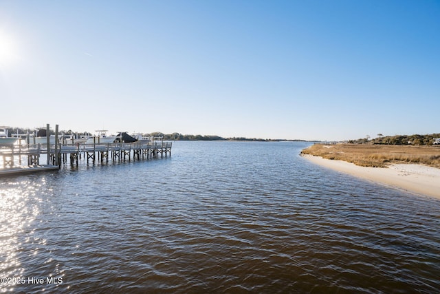 view of dock with boat lift and a water view