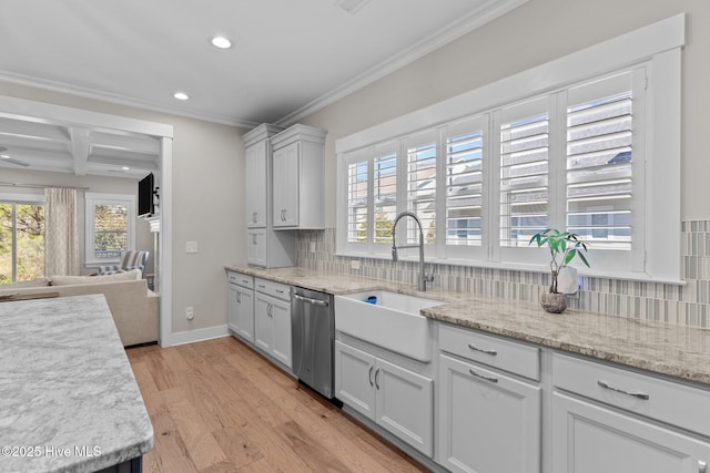 kitchen featuring a sink, stainless steel dishwasher, ornamental molding, light wood finished floors, and tasteful backsplash