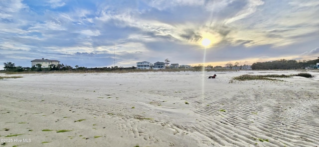 view of yard featuring a beach view and a water view