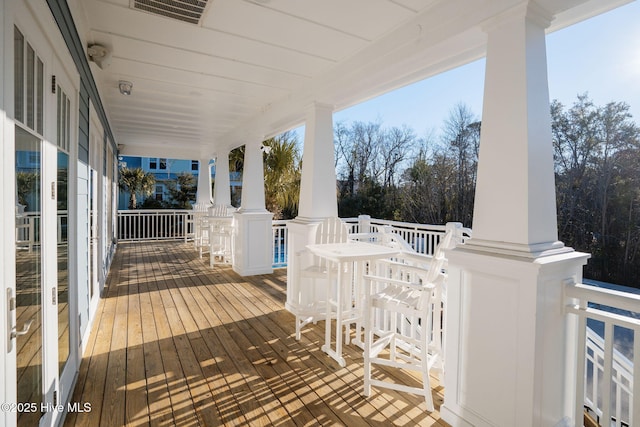 wooden deck featuring visible vents