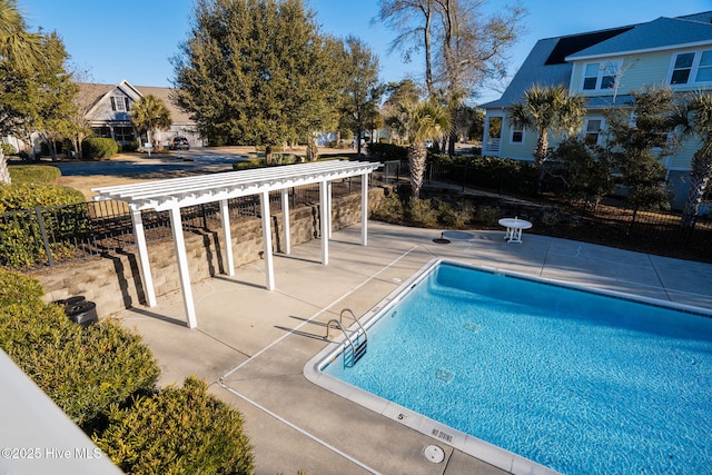 pool with a pergola, a patio area, and fence