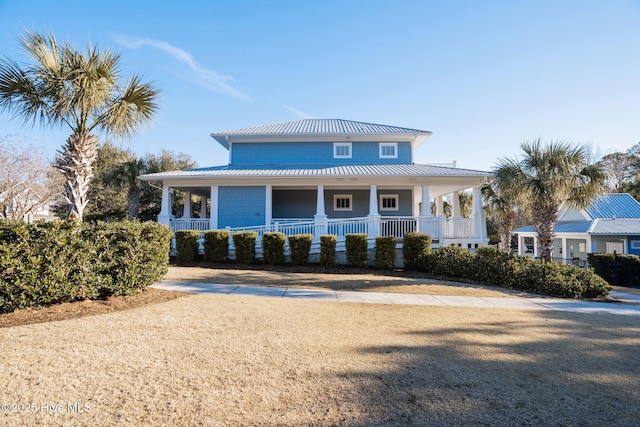 view of front of property with a porch, a standing seam roof, and metal roof