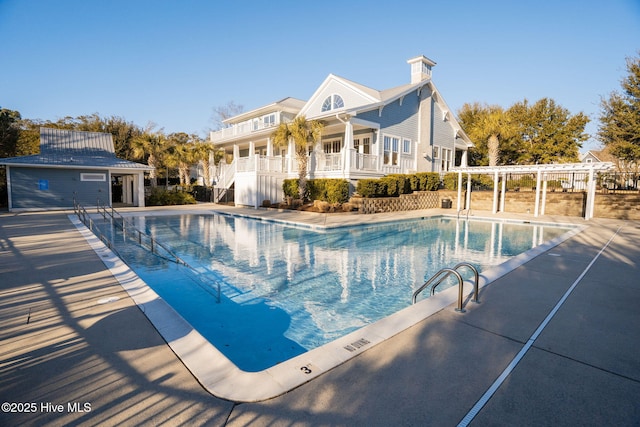 community pool with fence and a patio