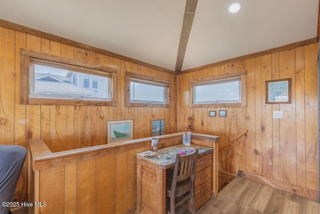 office area featuring lofted ceiling, wood walls, and light hardwood / wood-style flooring