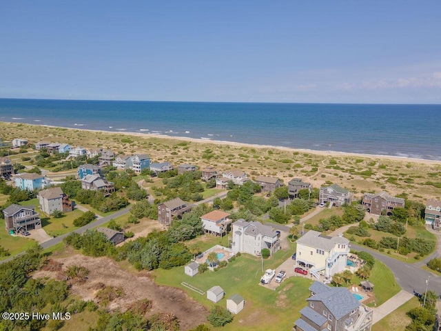 drone / aerial view with a beach view and a water view