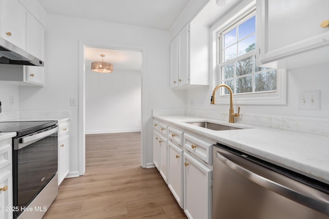 kitchen featuring stainless steel appliances, white cabinetry, pendant lighting, and sink