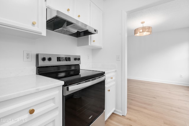 kitchen with range hood, electric stove, light hardwood / wood-style floors, and white cabinetry