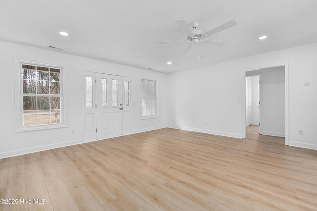 interior space with ceiling fan and light hardwood / wood-style flooring