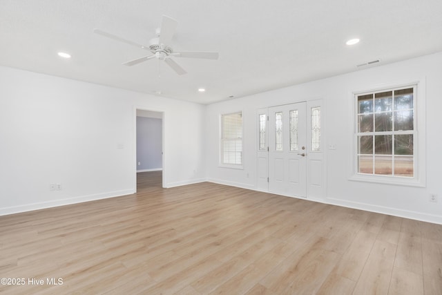 empty room featuring ceiling fan and light hardwood / wood-style flooring