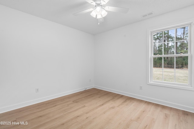 spare room with light hardwood / wood-style floors and ceiling fan