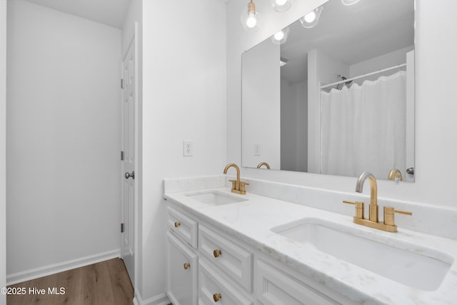 bathroom with hardwood / wood-style floors and vanity