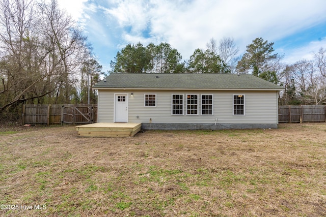 rear view of property with a deck and a lawn