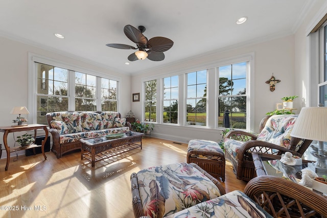 sunroom featuring ceiling fan