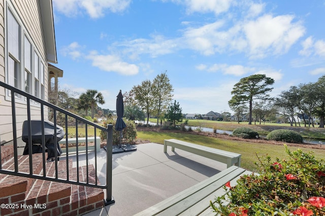 view of patio / terrace featuring a grill and a water view