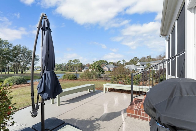 view of patio with a water view and area for grilling