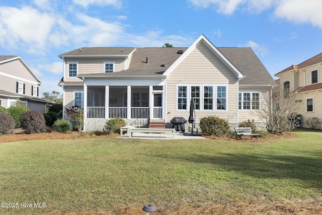 back of house featuring a sunroom, a yard, and a patio