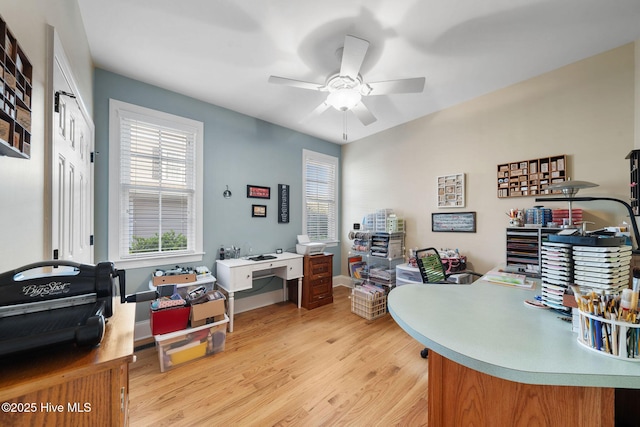 office space with ceiling fan and light hardwood / wood-style flooring