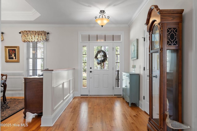 foyer entrance featuring light wood-type flooring and crown molding