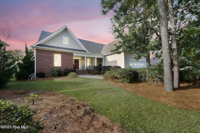 view of front of property featuring a garage and a lawn