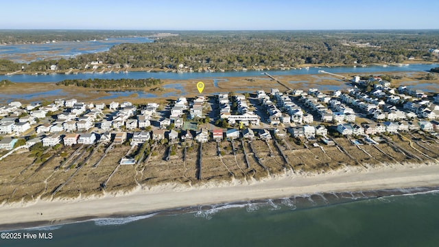 drone / aerial view featuring a beach view and a water view